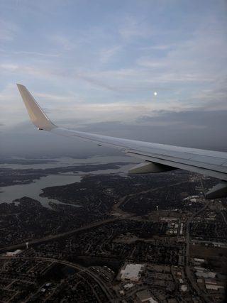 Watching the moon come up out of the window of a 737.